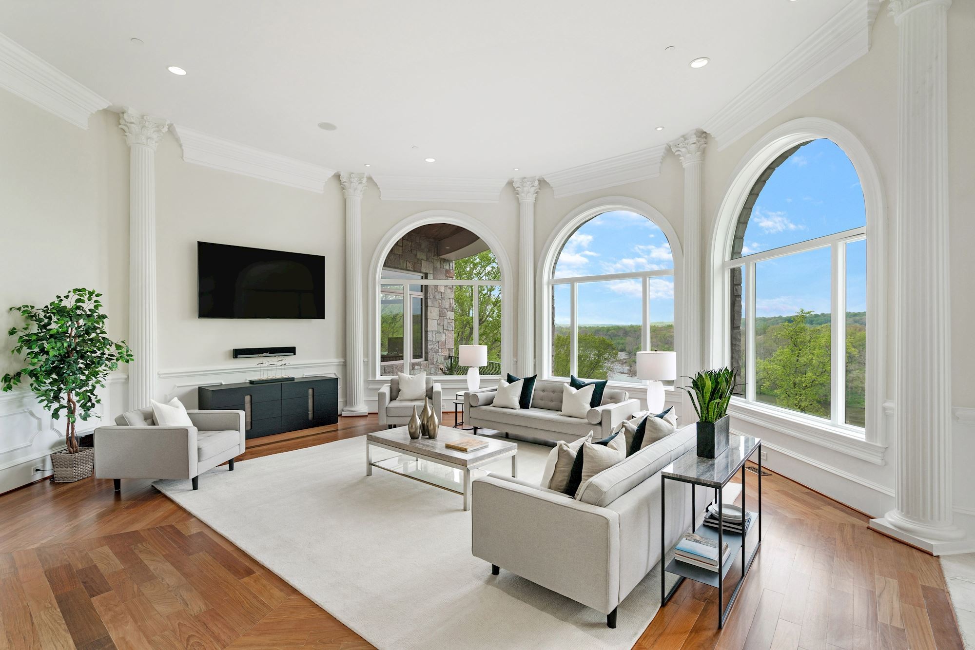 Family room with tall arched windows and river outlook