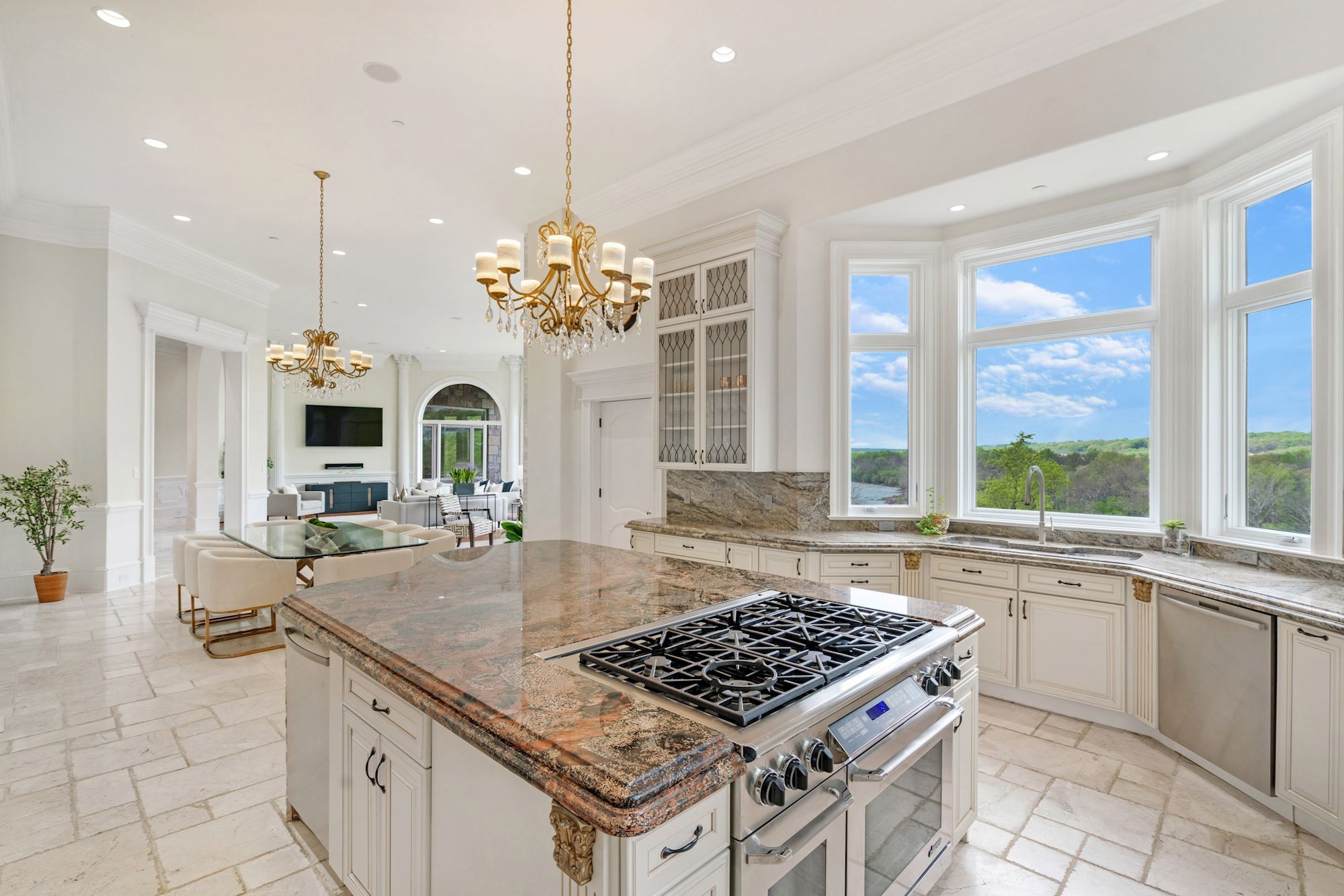 Kitchen with large central island and white cabinetry