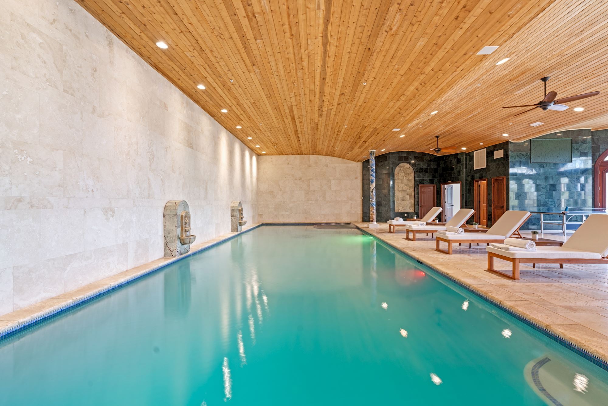 Indoor pool beneath an arched cedar ceiling