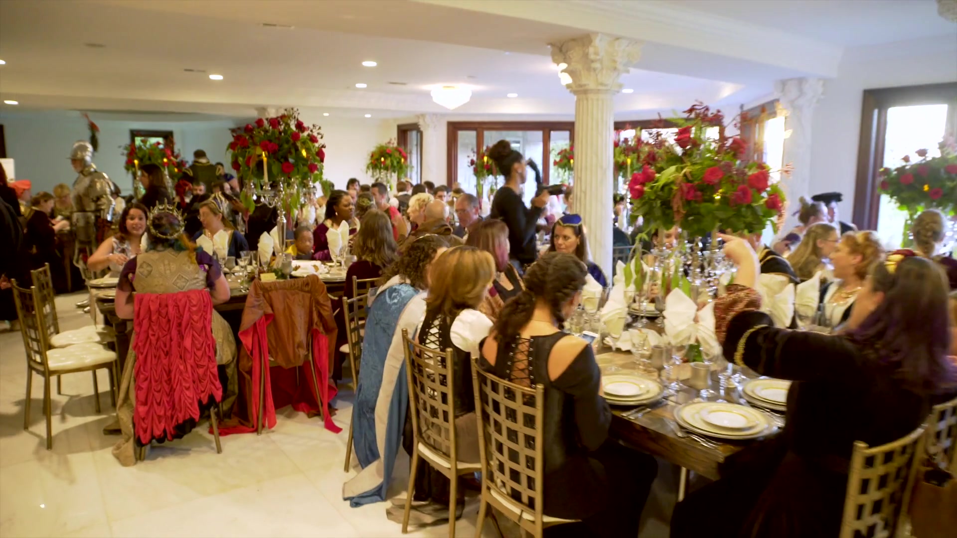Wedding guests seated at decorated dining tables in the grand ballroom