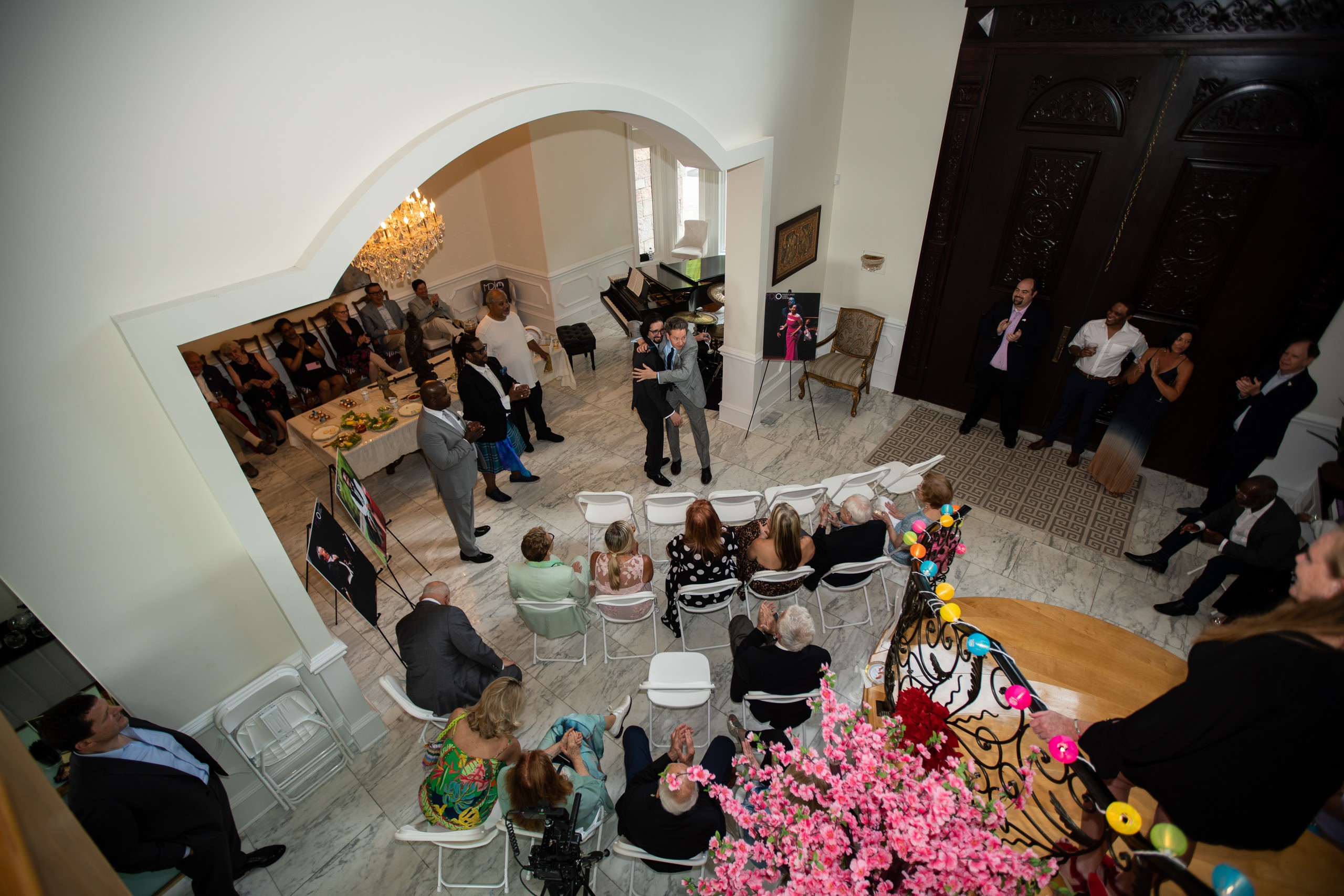 Guests seated for a performance viewed from the staircase