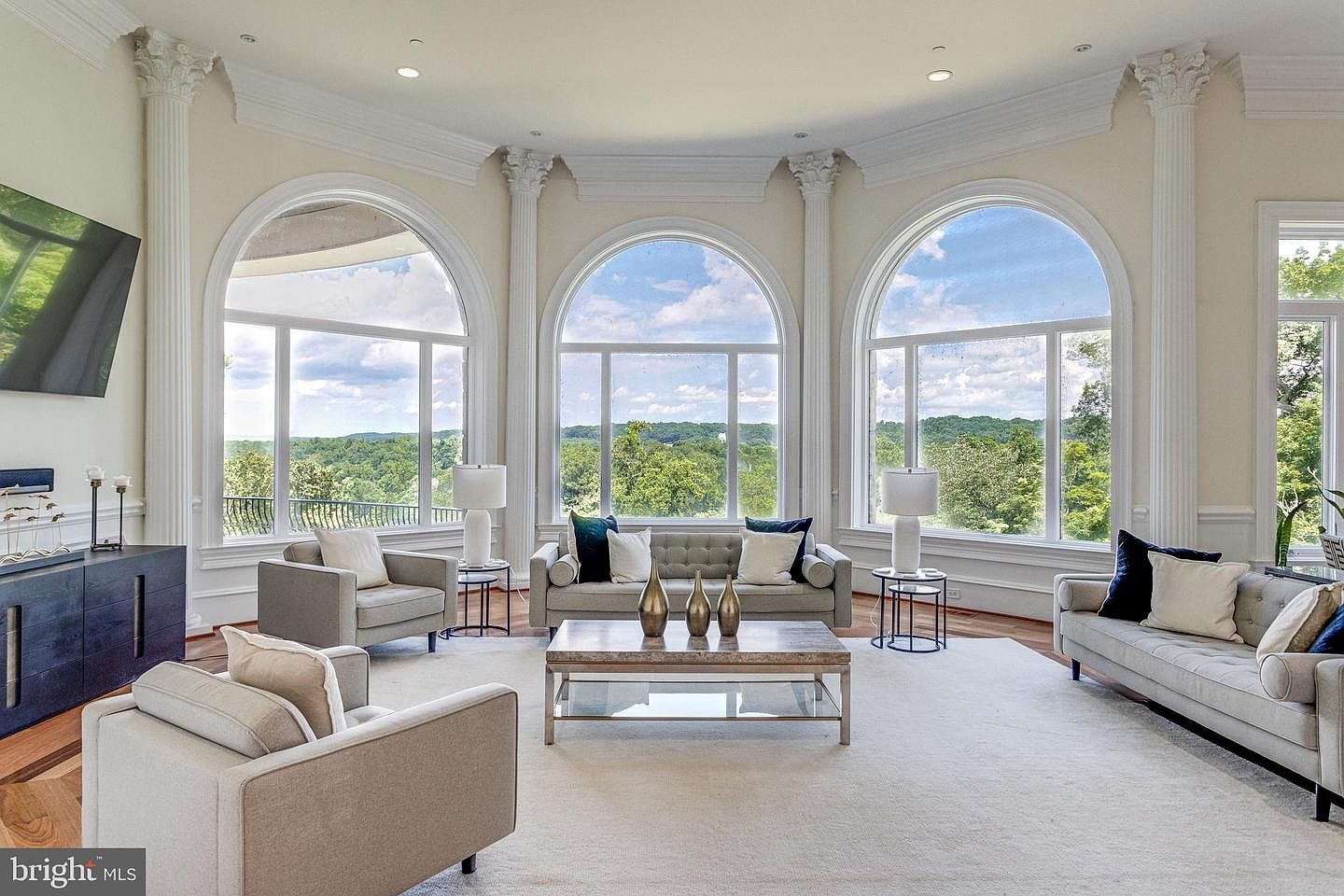 The family room, with arched windows toward the trees.