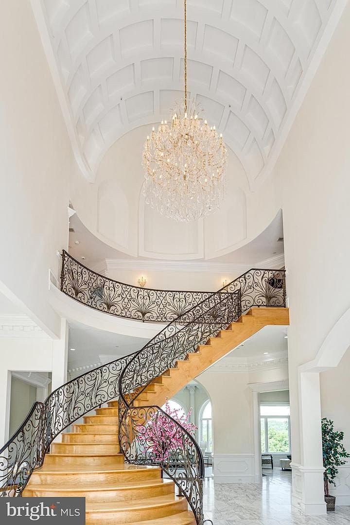 The stair rising through the foyer.