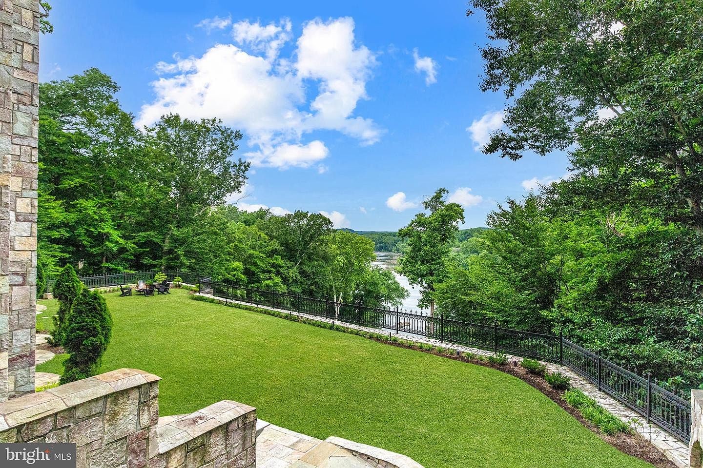 The lawn running toward the river.