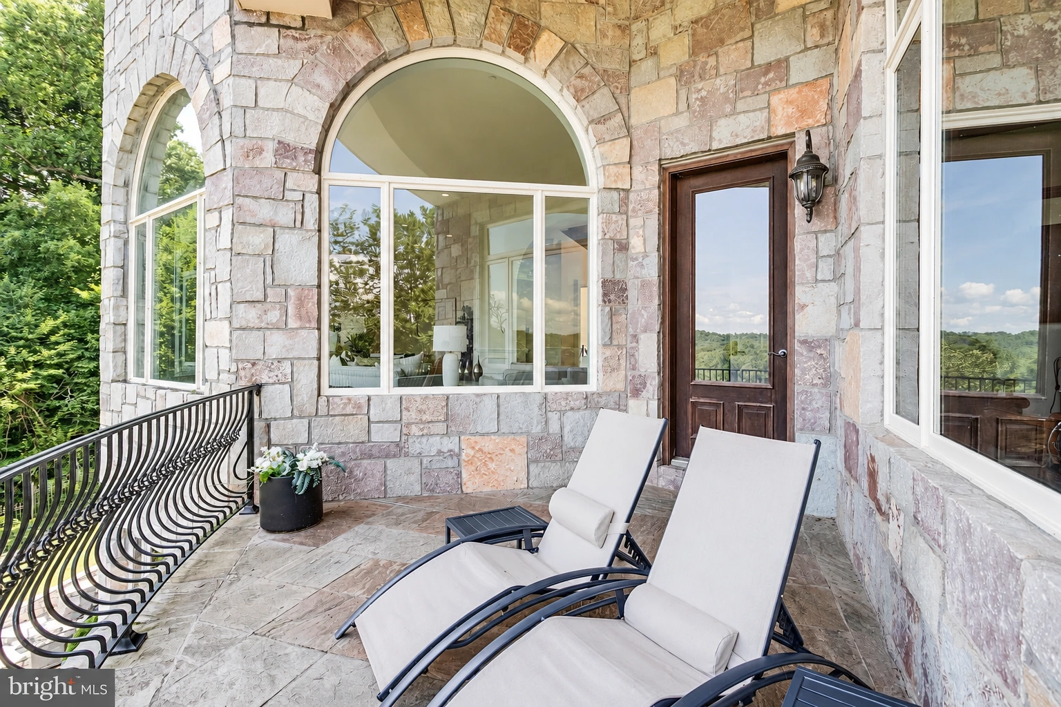 A stone loggia opening onto a rear balcony.